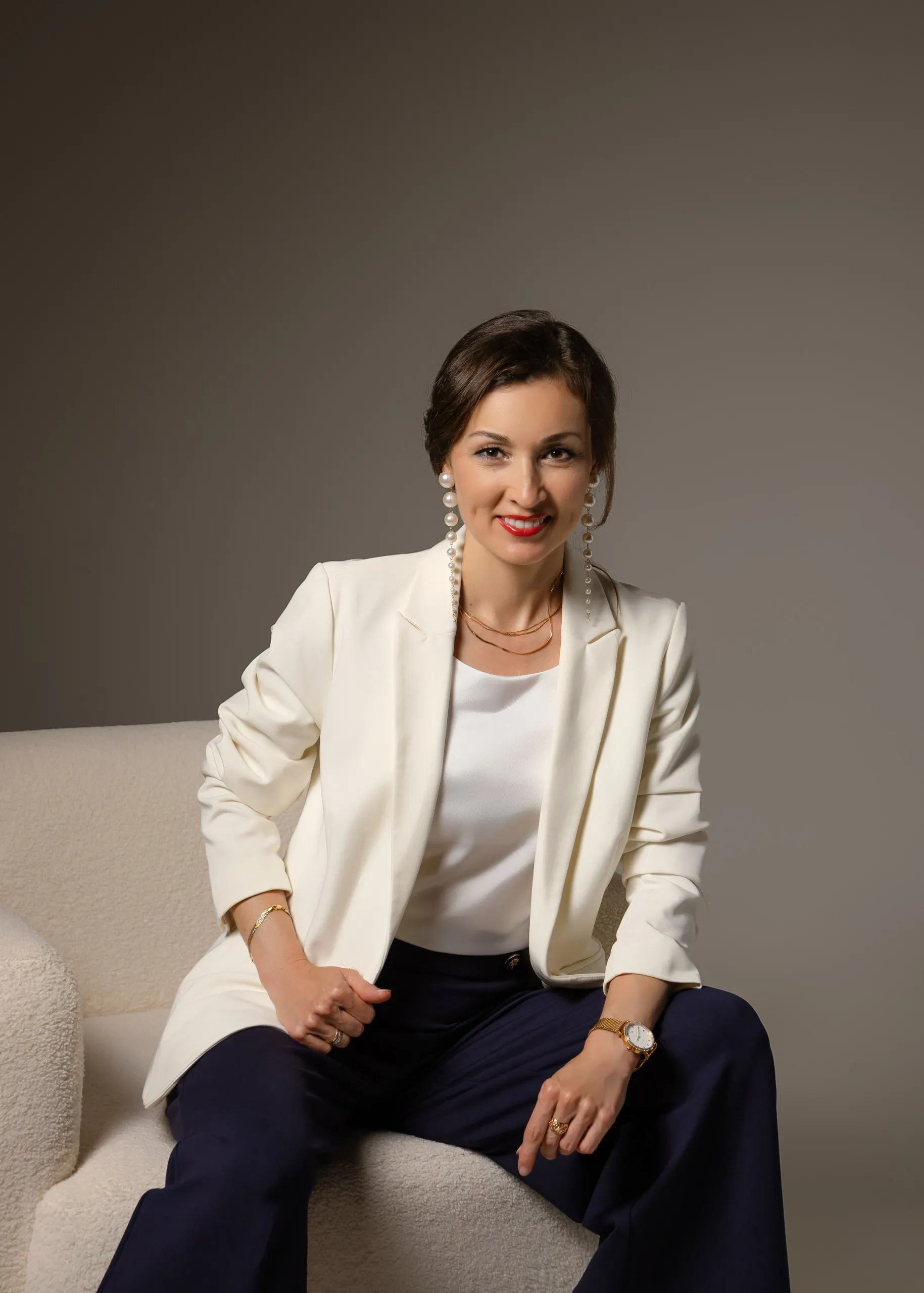 Liliya Ishkaeva seated in a white blazer